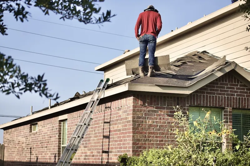 Professional roofer working on a residential roof in Bucks Mill